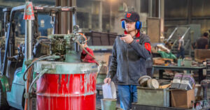 a University of Utah student rinsing off a piece of machinery